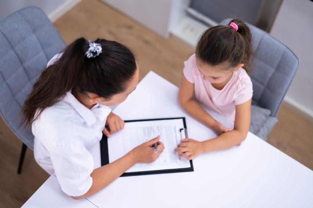 Sick Child Therapy. Therapist Comforting Kid